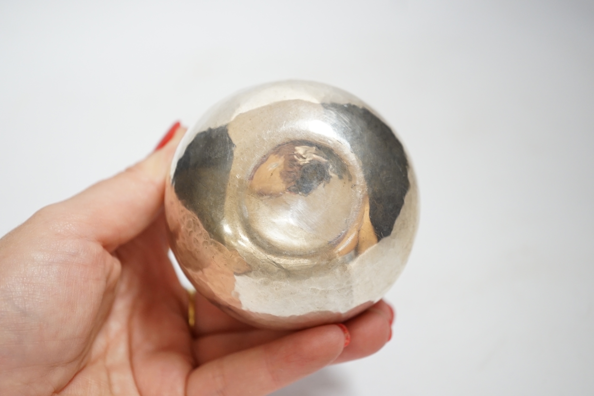 An Elizabeth II planished silver bowl with gilded interior, maker, C.M.H, London, 1985, height 57mm, 3.9oz.